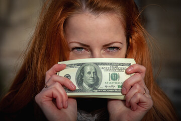 Portrait of young beautiful woman with US Dollar bills.