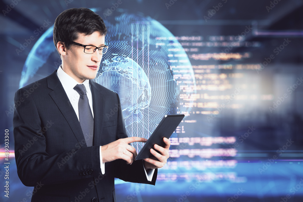 Poster Happy businessman using tablet with abstract globe and coding interface on blurry office background. Technology and programming concept. Double exposure.