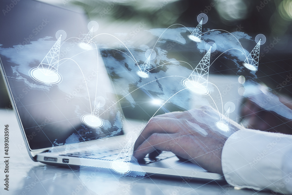 Poster businessman hand using laptop with creative glowing digital map with location pins on blurry backgro