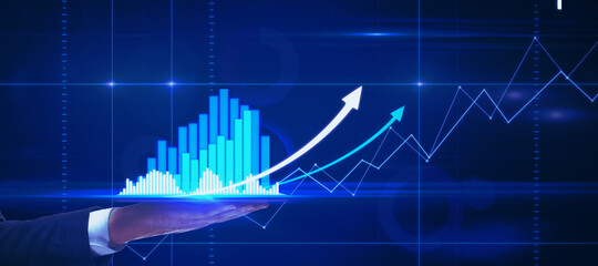 Businessman using tablet with glowing forex chart interface. Innovation and trade concept.