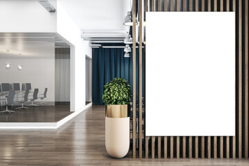 Blank white poster on wooden partition in stylish office space with tree in a flowerpot on wooden...