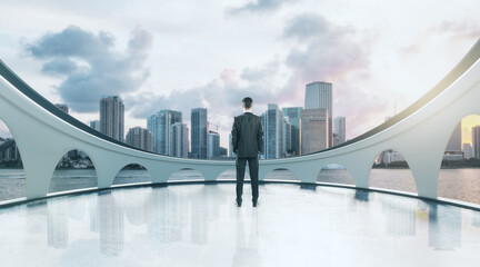 Thoughtful businessman standing on abstract balcony with city view. Success and vision concept.
