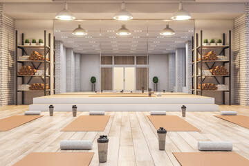 Luxury concrete yoga gym interior with equipment, daylight and wooden flooring. Healthy lifestyle concept. 3D Rendering.