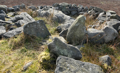 exposed stones at the top of a cairn known as the millers grave on midgley moor in calderdale west...