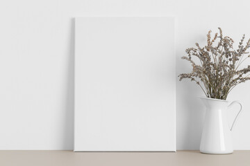 White canvas mockup with a lavender on the beige table.
