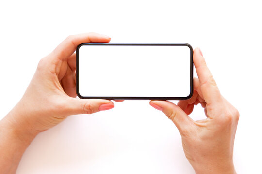 Person holding phone horizontally in both hands on white background
