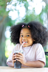 Children drink coca cola with food Childhood concepts and healthy eating.