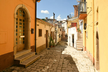 Ruvo del Monte, Italy, June 12, 2021. A narrow street among the old houses of a medieval village in the Basilicata region.