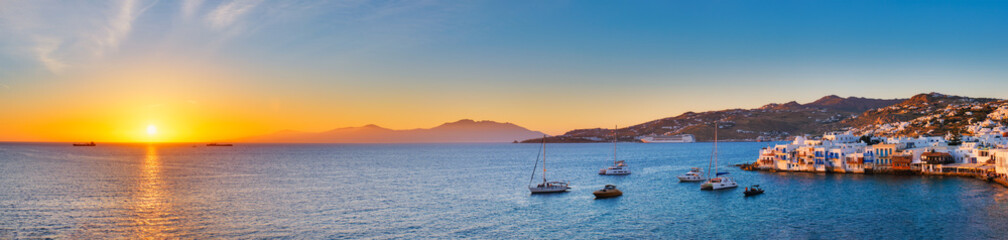 Sunset in Mykonos, Greece, with cruise ship and yachts in the harbor