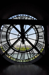 Naklejka premium View on the city through the clock mechanism