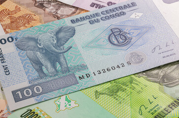 Close up on one hundred Francs of the Republic of Congo. Paper banknotes of the African country. Detailed capture of the front art design. Detailed money background wallpaper. Currency bank note