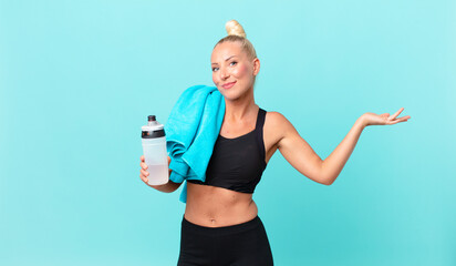 pretty blond woman feeling puzzled and confused and doubting. fitness concept