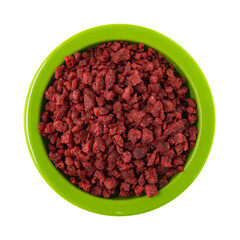 Green bowl filled with imitation bacon bits on a white background.