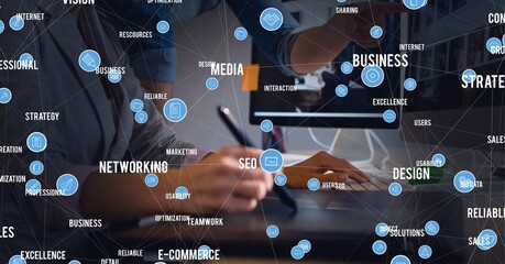 Network of digital icons against mid section of businessman and businesswoman working together