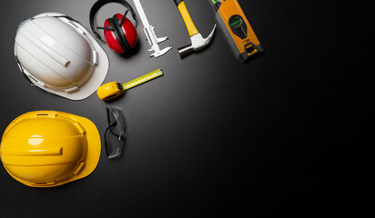 Work safety. Construction site protective equipment on wooden background, flat lay, copy space, top view