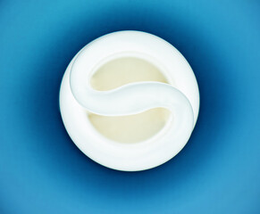White neon bulb on a blue textured background 