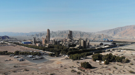 AERIAL. Top view of industry manufactory in UAE. Huge cement factory in desert.