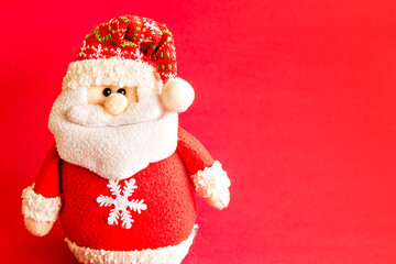 Santa Claus doll on red background.