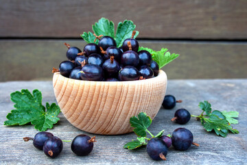 Jostaberry fruits in a wooden bowl