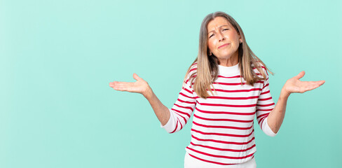 pretty middle age woman feeling puzzled and confused and doubting