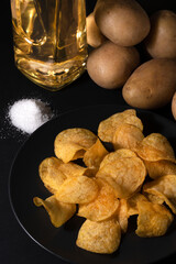 Crispy homemade chips on a plate. Ingredients for making chips 