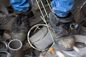 Wear safety shoes to ensure safety at work. construction workers wear safety shoes. People with...
