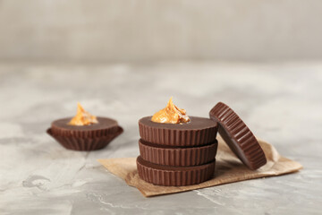 Delicious peanut butter cups on light grey table
