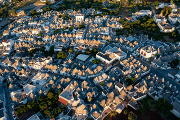Naklejka premium Aerial view of alberobello at sunset, the city of trulli in Puglia. a magical city and a beautiful landscape