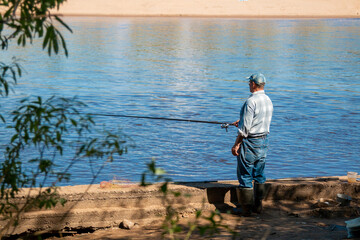 Obraz na płótnie Canvas Fisherman on the city river. Fishing on the city river.