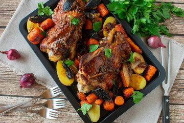 Roasted turkey legs with vegetables and potatoes