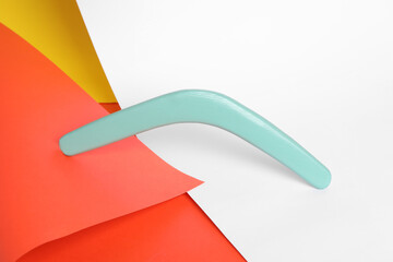 Turquoise boomerang on color background. Outdoor activity