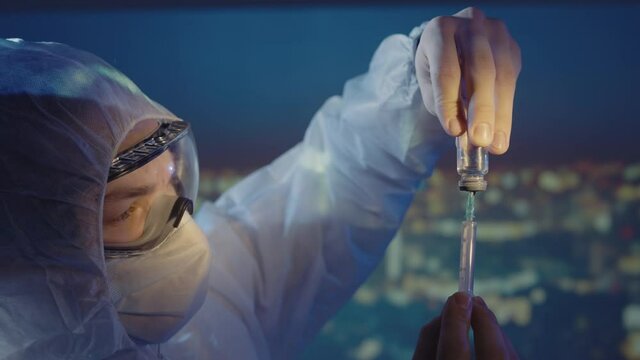 Doctor microbiologist scientist in a protective PPE suit