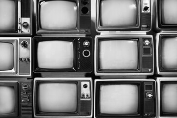 Retro black and white old televisions pile for background, close up