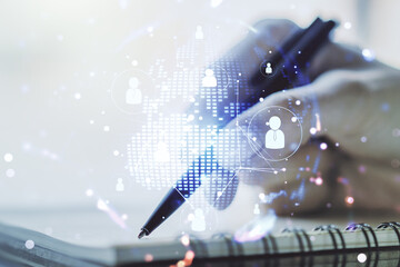 Double exposure of social network icons concept with world map and woman hand writing in notepad on...