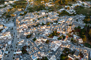 Aerial view of alberobello at sunset, the city of trulli in Puglia. a magical city and a beautiful...