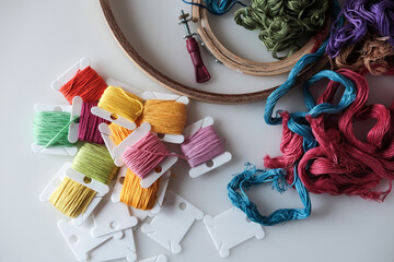 Top view on colorful embroidery floss bobbins. Embroidery threads and tools for handmade, crafts,...