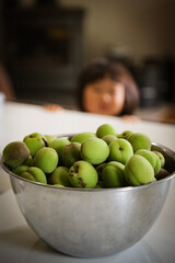 person holding bowl of peas