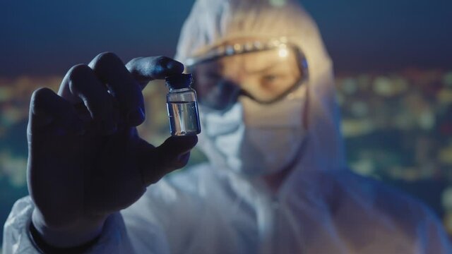 Doctor microbiologist scientist in a protective PPE suit