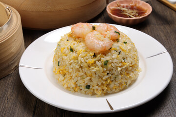shrimp prawn fried rice white plate sauce rustic wood background