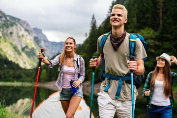 Group of happy hiker friends trekking as part of healthy lifestyle outdoors activity