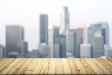 Wooden tabletop with beautiful blurry skyscrapers on background, mock up