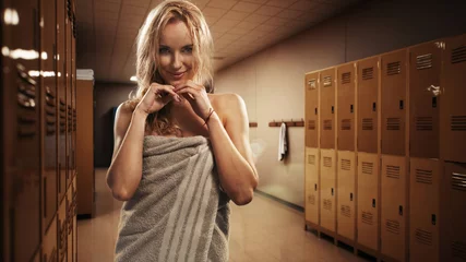 Poster Portrait of sweaty blonde woman take a break after intense workout. © konradbak