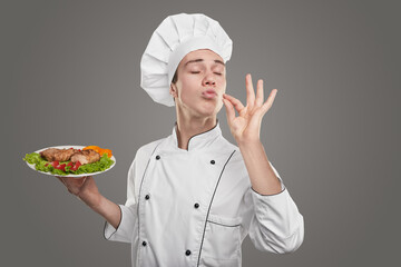 Chef with dish making delicious gesture
