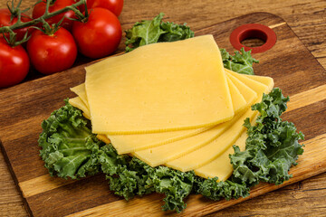 Sliced Gauda cheese over board