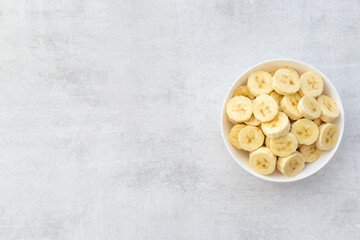 Banana slices in bowl. Fresh friuts top view