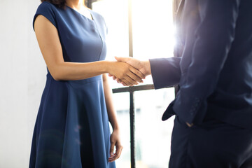 businessman and business woman shaking hands together on a business cooperation agreement. Successful businessmen handshaking after good deal