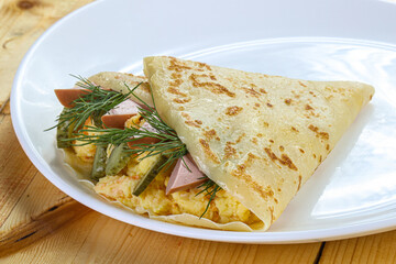 Pancake with potato and sausages