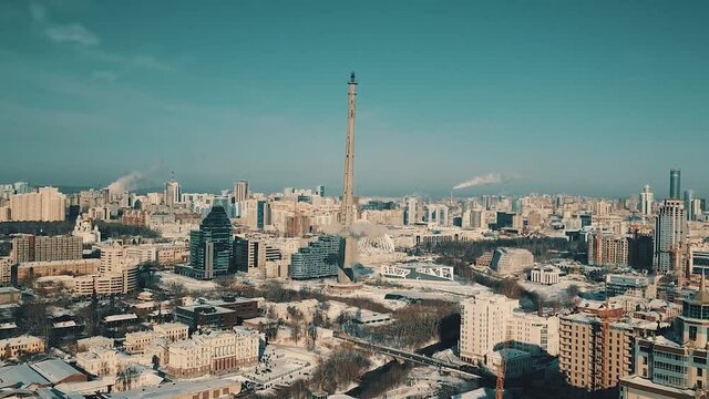 Demolition of the unfinished TV tower by a directional explosion with collapse of the structure, Ekaterinburg, Russia. Video. Aerial view of a cityscape in the summertime.