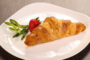 Sweet croissant in the plate