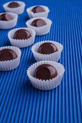 Vertical shot set of brown reflective chocolate candies.